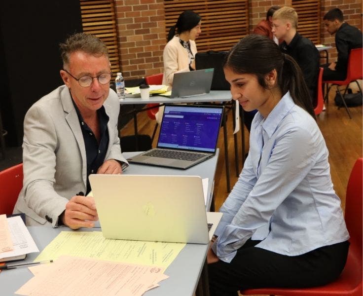 School principal interviewing a Year 10 student.