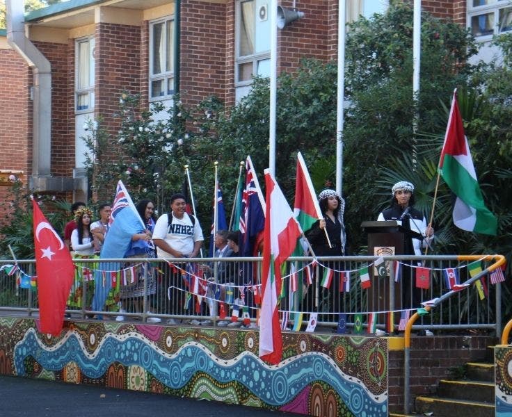 Students holding flags from their country of birth at our Diversity Day assembly.