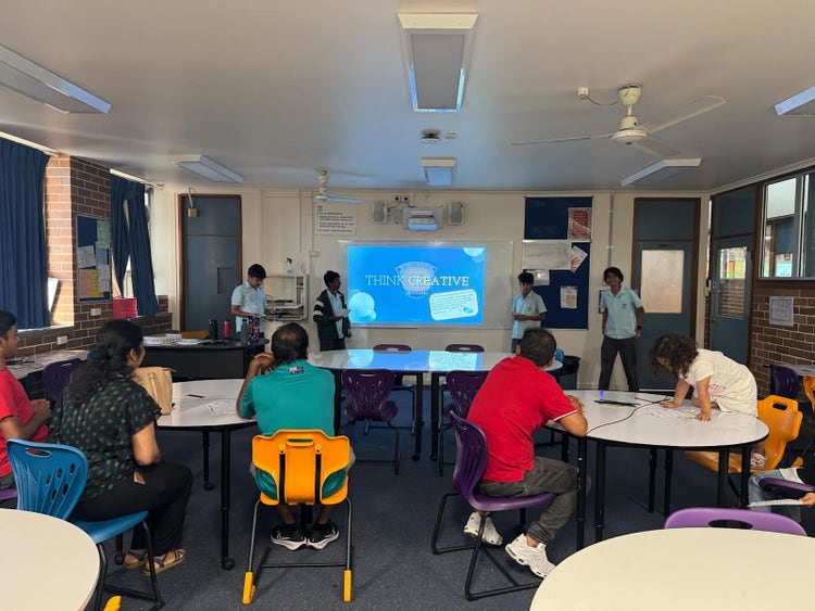 Students presenting to their peers at their showcase presentation.